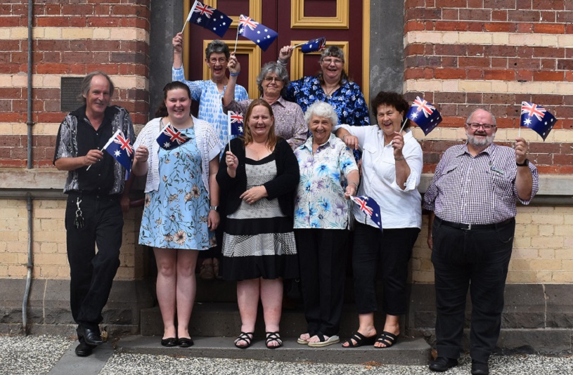 Group shot waving flags in front of Civic Centre.jpg